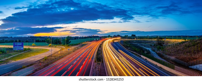 Colorful sunset at M1 motorway near Flitwick junction with cars light trails. United Kingdom - Powered by Shutterstock