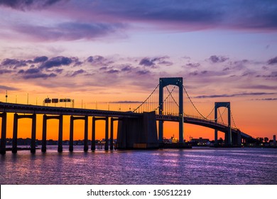 Colorful sunset over Long Island Sound and Throgs Neck Bridge in New York City