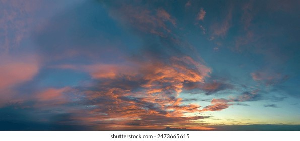 Colorful sunset sky with setting sun behind vivid orange and yellow clouds - Powered by Shutterstock