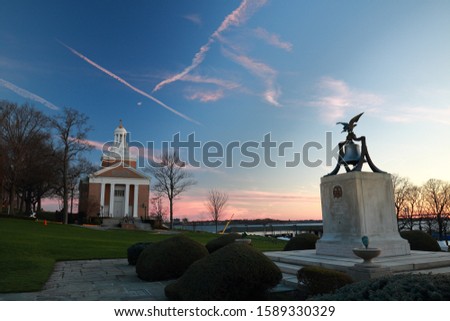Colorful Sunset at United States Merchant Marine Academy Chapel with Memorial Bell in Foreground
