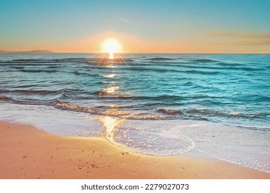 Colorful sunset viewed from the pink sea beach with soft waves - Powered by Shutterstock