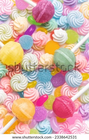 Colorful sweet lollipops and candies over white background.  Flat lay, top view