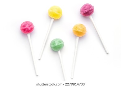 Colorful sweet lollipops over white background.  Flat lay, top view