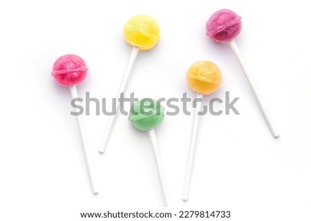Colorful sweet lollipops over white background.  Flat lay, top view