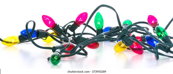 colorful tangled christmas lights on white background