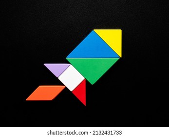 Colorful Tangram Puzzle Rocket on Black Background