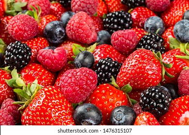 colorful tasty mix of wild forest berry fruits. Strawberry blueberry raspberry and blackberry. healthy eating nutrition vegan food concept background