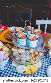 Colorful Tea Party With Chocolate Cupcakes, Biscuits, Muffins, Sweet Balls, Sausage Rolls, Pumpkin Quiche Set Out On A Fancy Cake Stand