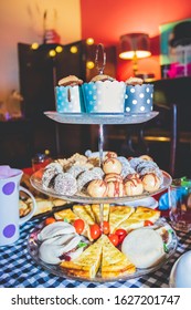 Colorful Tea Party With Chocolate Cupcakes, Biscuits, Muffins, Sweet Balls, Sausage Rolls, Pumpkin Quiche Set Out On A Fancy Cake Stand