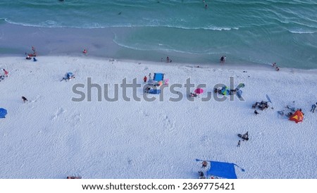 Colorful tents, beach lounge chairs, canopy and crowded of people swimming, relaxing, walking along white sandy shoreline with turquoise water, South Walton beach, Destin, Florida. Travel destination Stock photo © 