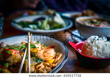 Colorful Thai food in a restaurant settings; various dishes on the table; colorful food, Asian food