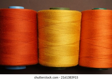 Colorful thread spool background, close-up. Multi Colored threads for sewing and needlework