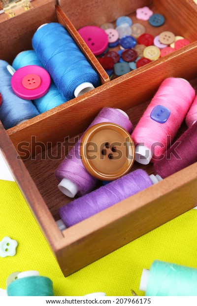 Colorful
threads for needlework in wooden box close
up