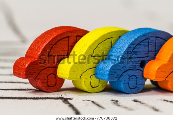 Colorful tiny cars depicting transportation\
and traffic for basic school kids safety education or the business,\
travel or transportation sectors.  \
