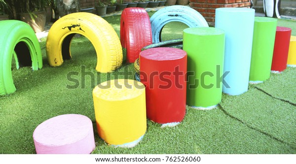 Colorful\
tire chairs and cylinder chairs at\
Playground