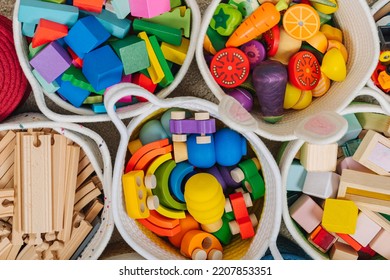 Colorful Toy Storage Baskets In The Children's Room. Cloth Stylish Baskets With Wooden Toys. Organizing And Storage Ideas In Nursery. Clean Up Toys And Reduce The Clutter. Top View