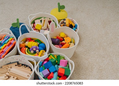 Colorful Toy Storage Baskets in the children's room. Cloth stylish Baskets with wooden toys. Organizing and Storage Ideas in nursery. Clean up toys and reduce the clutter. House cleaning. - Shutterstock ID 2208765083