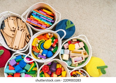 Colorful Toy Storage Baskets In The Children's Room. Cloth Stylish Baskets With Wooden Toys. Organizing And Storage Ideas In Nursery. Clean Up Toys And Reduce The Clutter. Top View