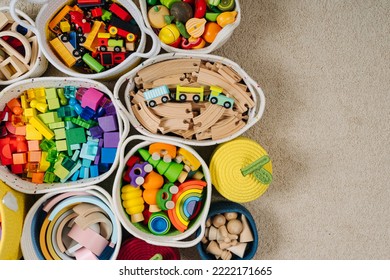 Colorful Toy Storage Baskets In The Children's Room. Cloth Stylish Baskets With Wooden Toys. Organizing And Storage Ideas In Nursery. Clean Up Toys And Reduce The Clutter. Top View