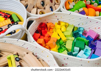 Colorful Toy Storage Baskets In The Children's Room. Cloth Stylish Baskets With Wooden Toys. Organizing And Storage Ideas In Nursery. Clean Up Toys And Reduce The Clutter. Top View