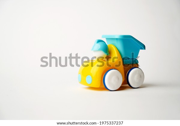 Colorful toy truck on a white background with copy\
space. Construction truck\
toy