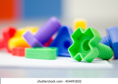 Colorful toys bolts and nut with blurry effect for wallpaper. Blur background.