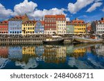 Colorful traditional houses in the Old port of Nyhavn in Copenhagen, Denmark. Nyhavn port is a popular travel destination and main landmark of Copenhagen city.