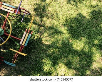 Colorful Traditional Metal Carousel/merry Go Round/roundabout On Playground In Sunny Day With Copy Space Of Shadow Of Trees On Lawn As Background - Childhood Holiday Joyful Memory Concept - Top View