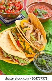 Colorful Traditional Mexican Food Dishes: Various Fajitas, Salsa Verde, Tomato Salsa, Salsa Cruda Served On A Beautifully Decorated Table