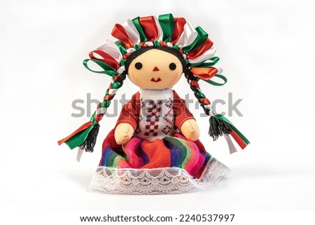 Colorful traditional Mexican rag handmade doll isolated in white.
Doll with long braids and ribbons using the colors of the Mexican flag. Foto stock © 
