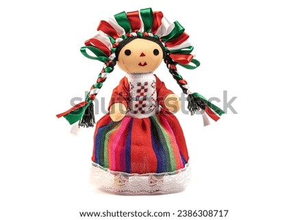 Colorful traditional Mexican rag handmade doll isolated in white.
Doll with long braids and ribbons using the colors of the Mexican flag.

