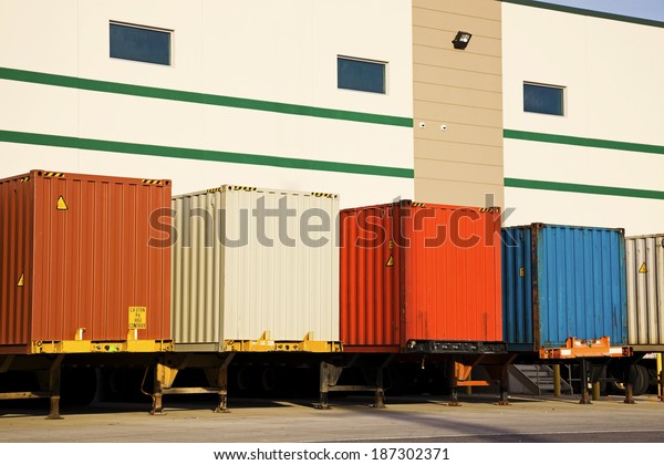 Colorful trailers by the\
warehouse