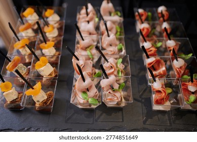 Colorful trays display an array of appetizers featuring meats, cheeses, and garnishes. Each bite-sized treat is carefully arranged and ready to delight guests at a festive gathering.