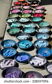 Colorful Trays Of Pastel Chalk Lined Up According To Hue And Color On A Sidewalk For A Sidewalk Art Festival In The Sunshine.