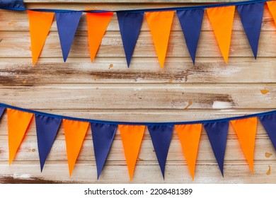 Colorful Triangle Flags Hanging On Ropes On Wooden Wall Background