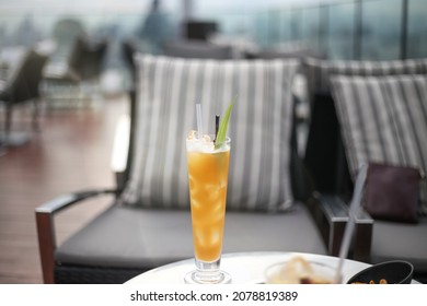 Colorful Tropical Cocktail Glass On A Table In An Empty Rooftop Bar During Sunset