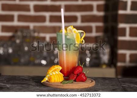 colorful tropical cocktail with layers and fruit garnishes 