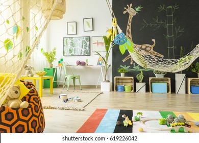 Colorful tropical themed room for kids with blackboard wall