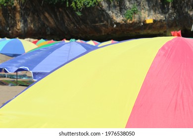 Colorful Umbrella On The Tropical Beach. Content Contains Chrominance Noise, Luminance Noise, Sharpening Noise, Or Film Grain