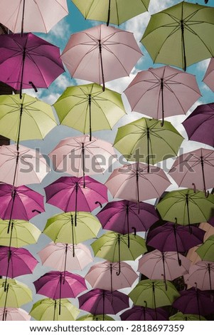 Colorful umbrella pattern floating in the sky, lots of umbrellas