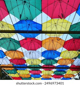 Colorful Umbrellas Decorate Outdoor Space During Bright Sunny Day - Powered by Shutterstock