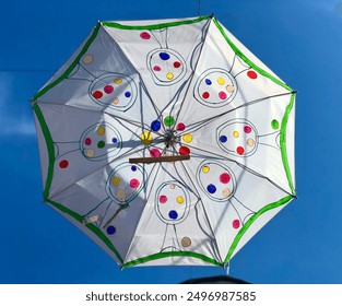 Colorful Umbrellas Decorate Outdoor Space During Bright Sunny Day - Powered by Shutterstock