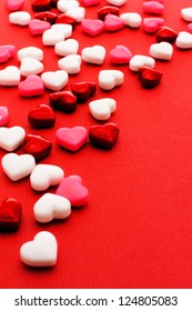 Colorful Valentines Day Heart Shaped Candy Border On Red Paper Background