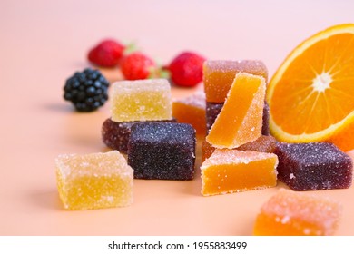 A colorful variety traditional French fruit jellies with fresh variant fruit as strawberry, blackberry and orange. The main ingredient are concentrate fruit paste, sugar and pectin dusting with sugar  - Shutterstock ID 1955883499