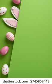 Colorful vertical decorated Easter eggs and playful bunny ears peek from a vibrant green paper background creating a pastel holiday composition with ample blank space for text or seasonal design
