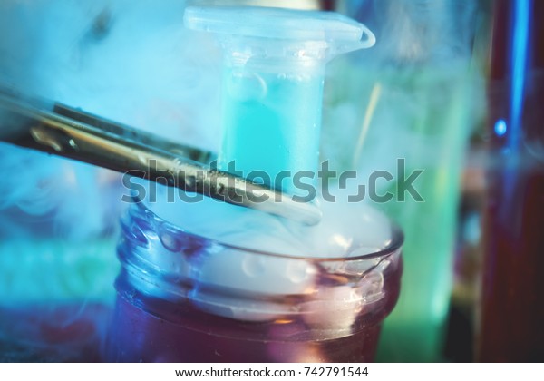 Colorful\
vial with dry ice for cryopreservation. Cryosample of stem cells in\
culture medium with cryoprotector DNA sequencing CRISPR genome\
research liquid nitrogen test tubes stem\
cell