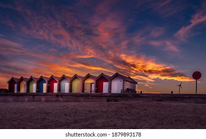 Colorful vibrant beach huts and promenade on the seafront with beautiful cloudy sunset behind. Blyth, Northumberland, UK. British tourism destination. - Powered by Shutterstock