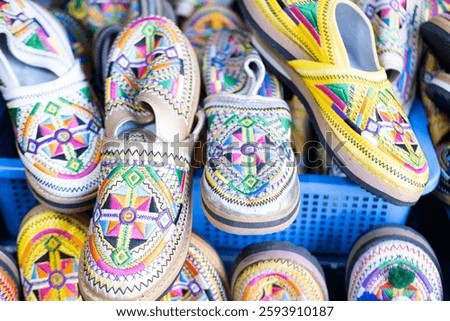 Colorful Vibrant leather handmade Moroccan slippers, babouches for sale in traditional local souk, story heritage and authentic oriental craftsmanship, artisanal culture Morocco