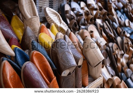 Colorful Vibrant leather handmade Moroccan slippers, babouches for sale in traditional local souk, story heritage and authentic oriental craftsmanship, artisanal culture Morocco