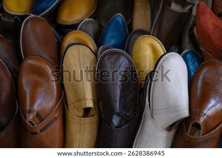 Colorful Vibrant leather handmade Moroccan slippers, babouches for sale in traditional local souk, story heritage and authentic oriental craftsmanship, artisanal culture Morocco
